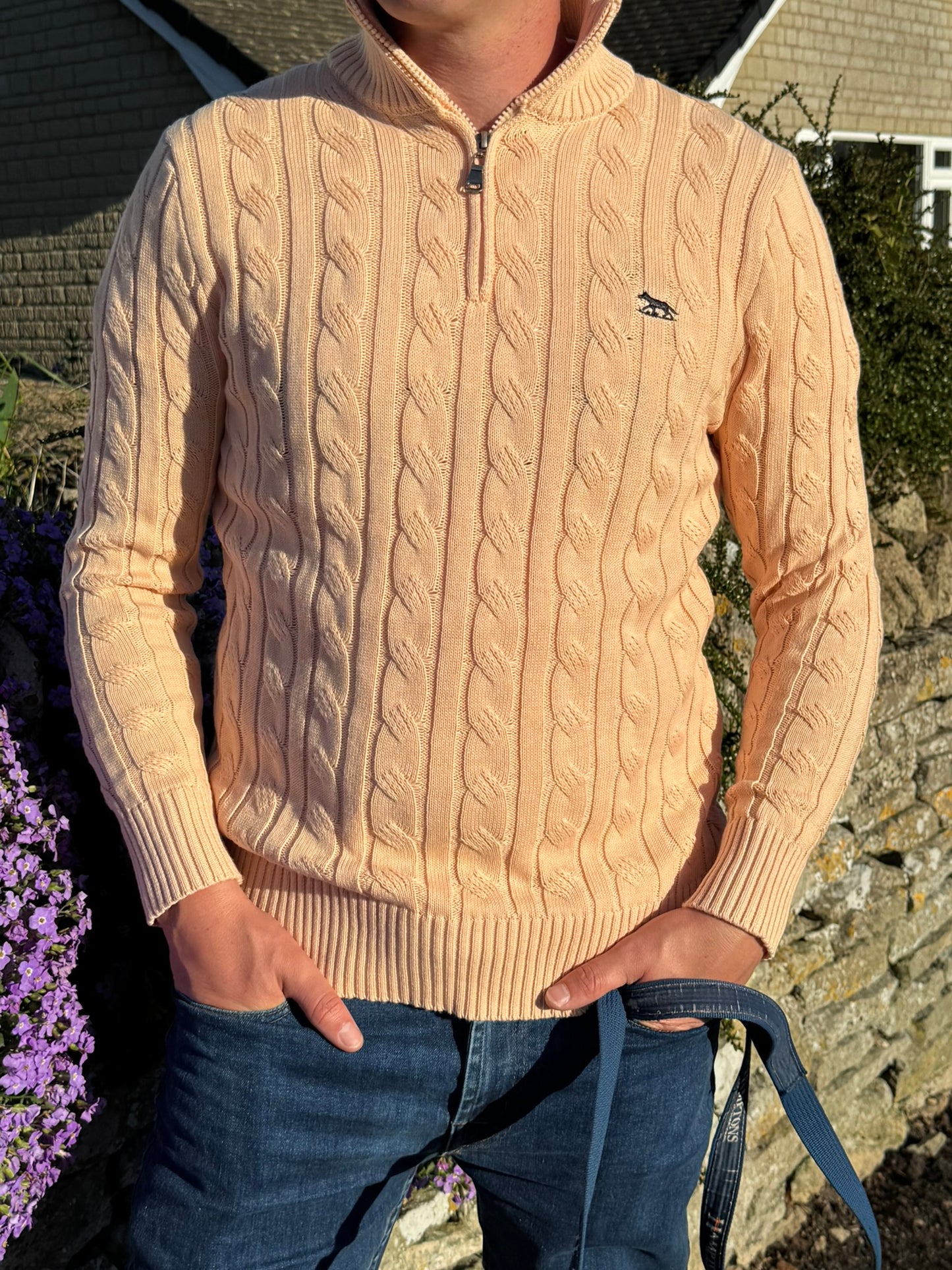 Close up of peach quarter zip 