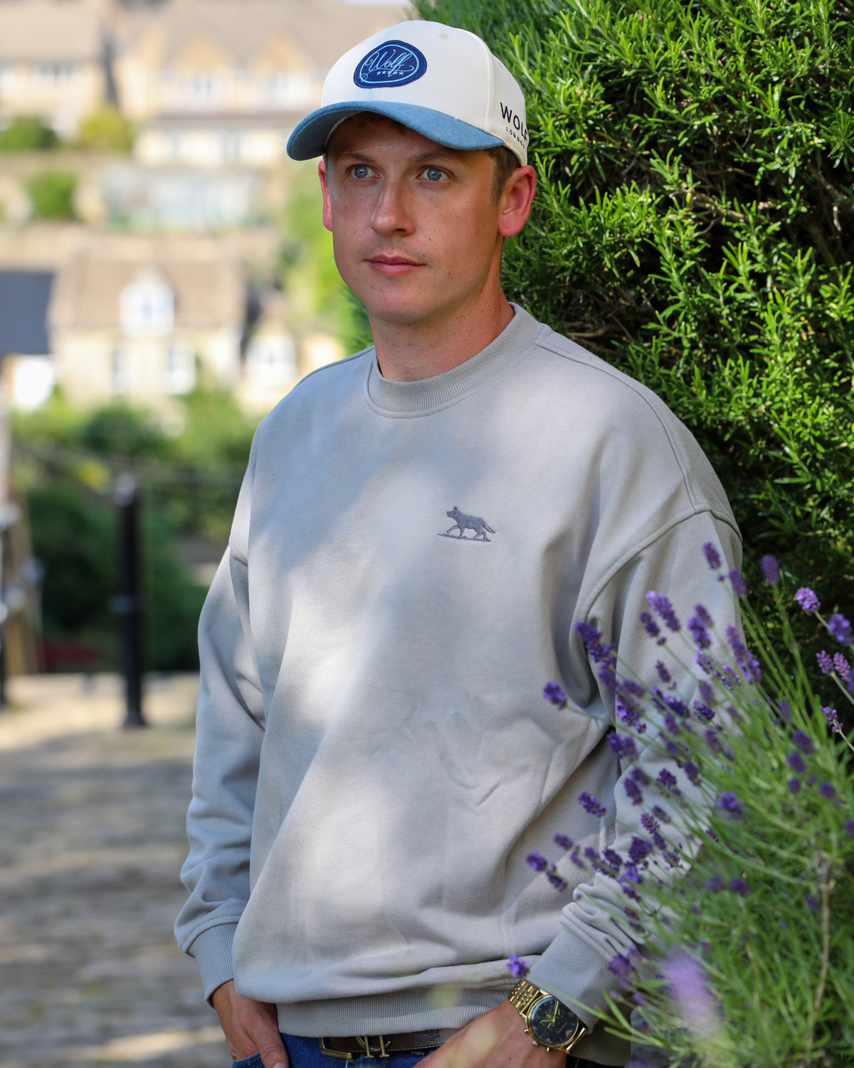 Men's Grey Oversized Crewneck Jumper  wearing an American Wolf London Trucker Cap in Cream & Denim Blue front view