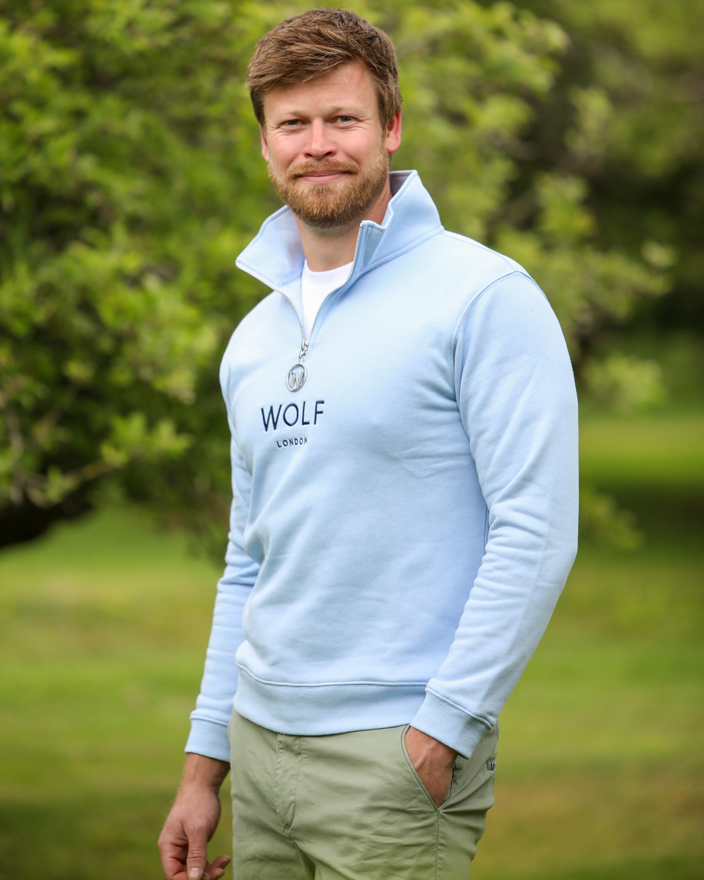 Men's blue quarter zip front side view with collar up