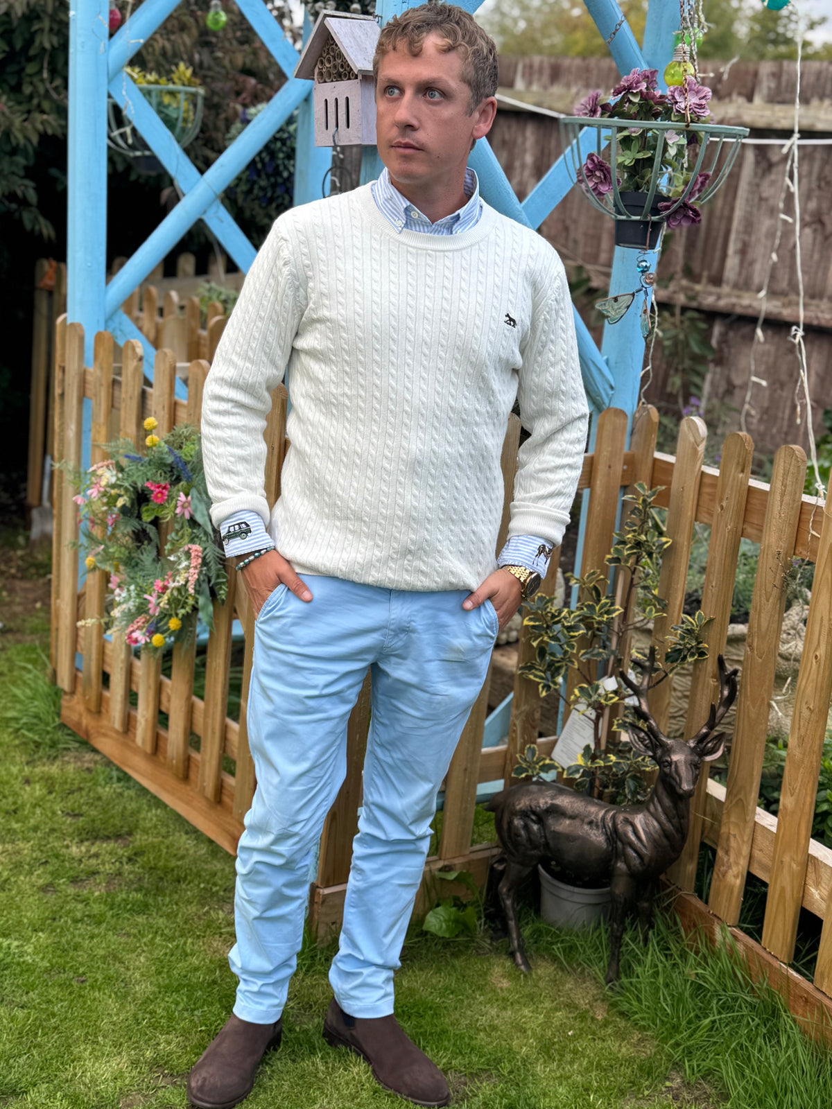 Men's white cable knit jumper whilst wearing Blue Chinos and Fairfax & Favour Chelsea boots